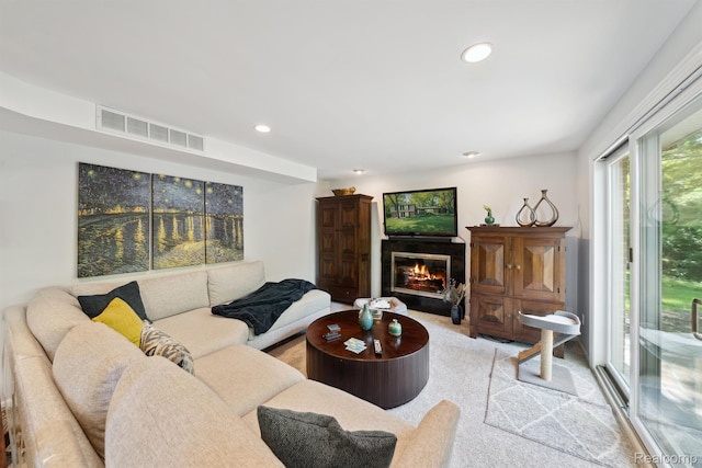 2650 Binbrooke Dr, Troy, MI 48084 - living room with recessed lighting, a glass covered fireplace, and light carpet