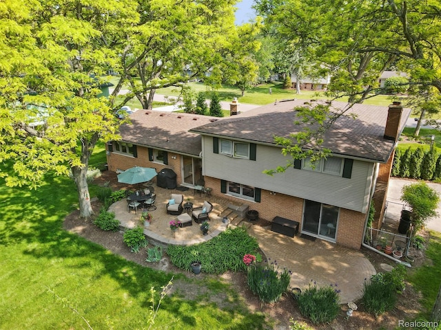 2650 Binbrooke Dr, Troy, MI 48084 - back of house with brick siding, a patio area, a chimney, and a lawn