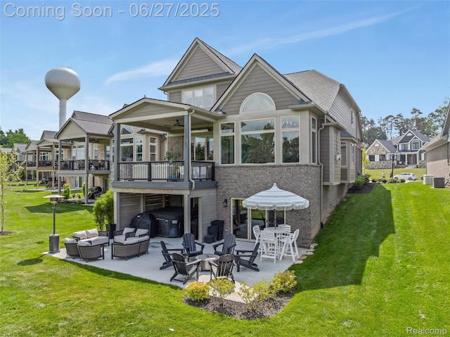 8264 Stoney Creek Dr, South Lyon, MI 48178 - back of property featuring an outdoor living space, a lawn, a patio area, a ceiling fan, and brick siding