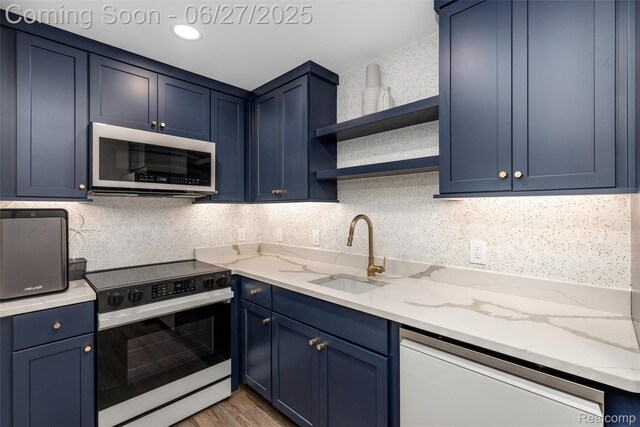 8264 Stoney Creek Dr, South Lyon, MI 48178 - kitchen with electric range oven, dishwasher, blue cabinets, and open shelves