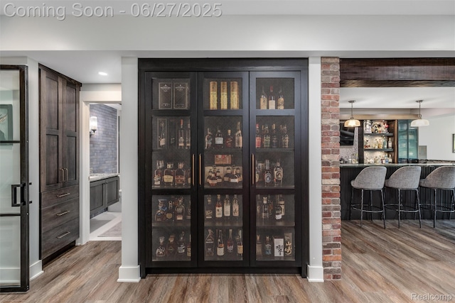 8264 Stoney Creek Dr, South Lyon, MI 48178 - indoor bar with wood finished floors and decorative light fixtures