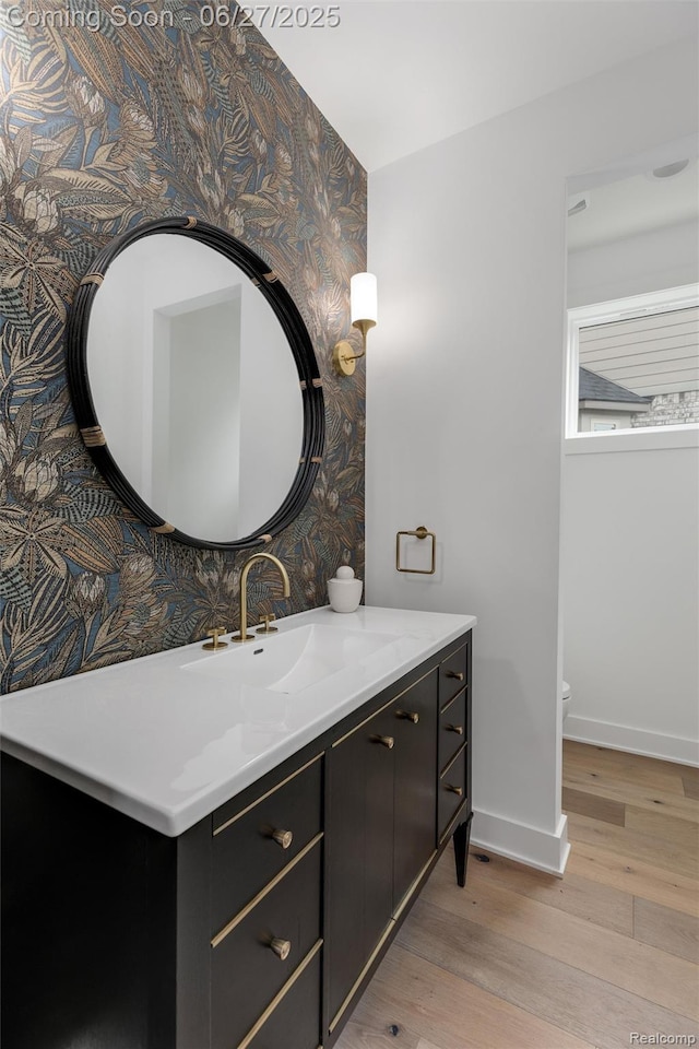 8264 Stoney Creek Dr, South Lyon, MI 48178 - bathroom featuring wallpapered walls, vanity, and wood finished floors