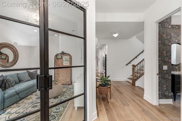 8264 Stoney Creek Dr, South Lyon, MI 48178 - foyer entrance with light wood-style flooring and stairs