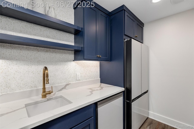 8264 Stoney Creek Dr, South Lyon, MI 48178 - kitchen with open shelves, freestanding refrigerator, blue cabinets, tasteful backsplash, and light stone countertops