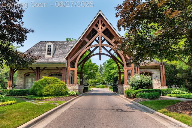 8264 Stoney Creek Dr, South Lyon, MI 48178 - view of asphalt street with curbs and a gated entry