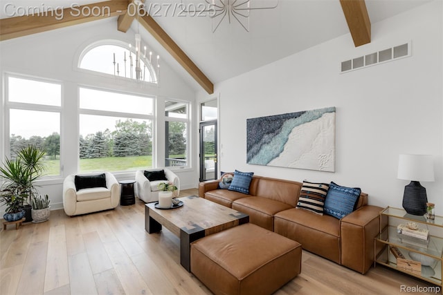 8264 Stoney Creek Dr, South Lyon, MI 48178 - living room featuring beamed ceiling, light wood-style flooring, a chandelier, and high vaulted ceiling