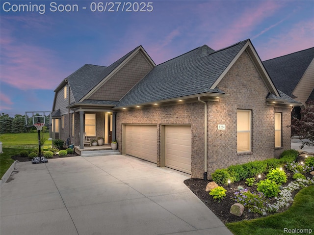 8264 Stoney Creek Dr, South Lyon, MI 48178 - craftsman inspired home featuring an attached garage, driveway, brick siding, roof with shingles, and a porch