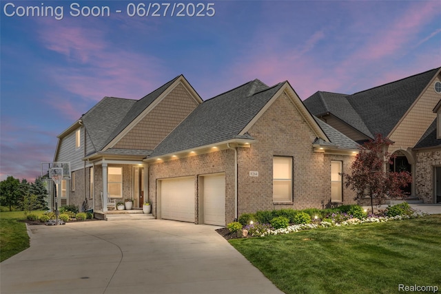 8264 Stoney Creek Dr, South Lyon, MI 48178 - view of front facade featuring a garage, concrete driveway, brick siding, and a yard