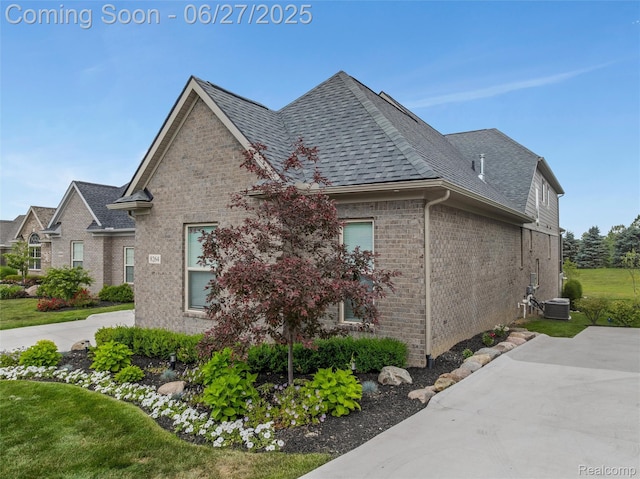 8264 Stoney Creek Dr, South Lyon, MI 48178 - view of property exterior with brick siding and roof with shingles
