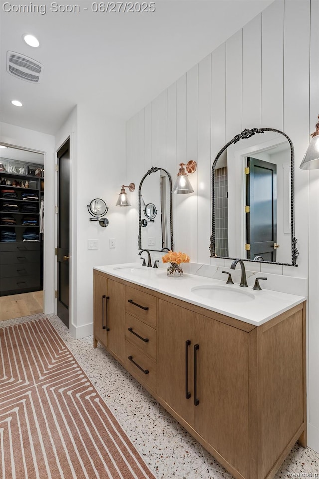 8264 Stoney Creek Dr, South Lyon, MI 48178 - bathroom featuring double vanity, speckled floor, and recessed lighting