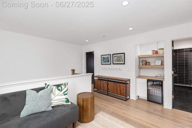 8264 Stoney Creek Dr, South Lyon, MI 48178 - sitting room with beverage cooler, light wood-style floors, and recessed lighting