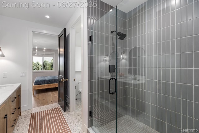 8264 Stoney Creek Dr, South Lyon, MI 48178 - ensuite bathroom with vanity, a stall shower, speckled floor, and recessed lighting