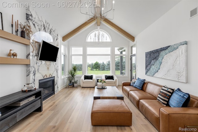 8264 Stoney Creek Dr, South Lyon, MI 48178 - living area featuring a chandelier, light wood-style floors, and a high end fireplace