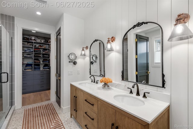 8264 Stoney Creek Dr, South Lyon, MI 48178 - bathroom with double vanity, a stall shower, a walk in closet, and speckled floor