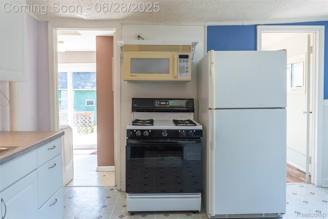 21312 Saint Francis St, Farmington Hills, MI 48336 - kitchen with white appliances, light countertops, a textured ceiling, and white cabinets