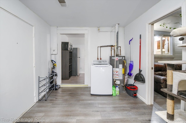 8021 Benson Rd, Mount Morris, MI 48458 - below grade area with washer / clothes dryer, water heater, and wood finished floors