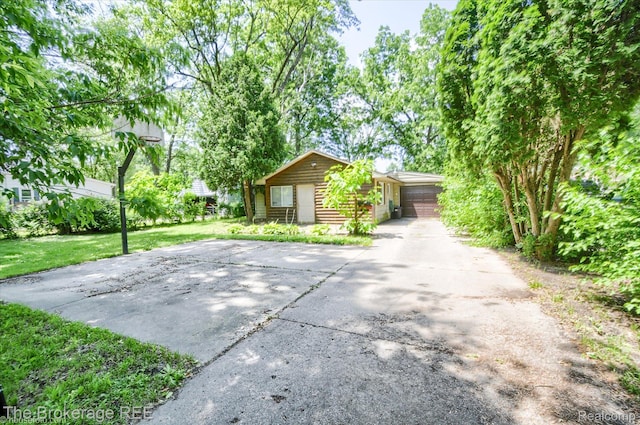 8021 Benson Rd, Mount Morris, MI 48458 - view of front facade featuring concrete driveway and a front yard