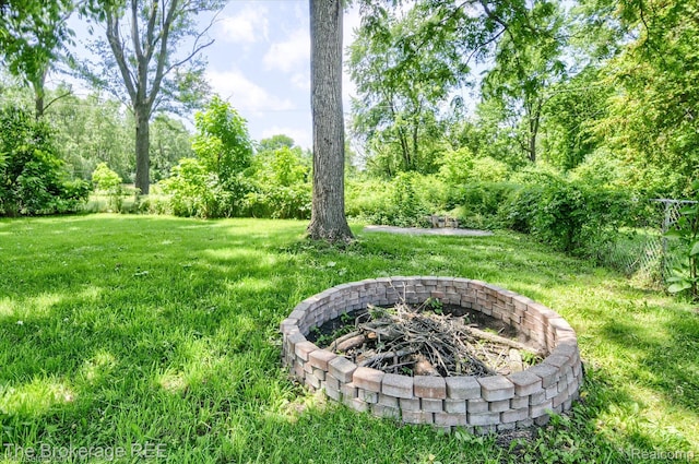 8021 Benson Rd, Mount Morris, MI 48458 - view of grassy yard featuring an outdoor fire pit