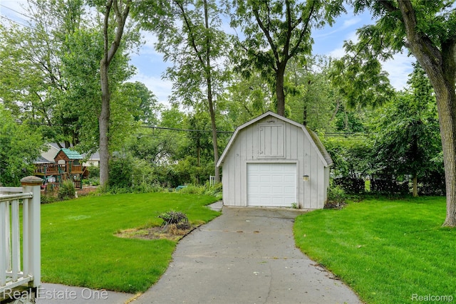 21462 Meridian Rd, Grosse Ile, MI 48138 - detached garage with concrete driveway and view of wooded area