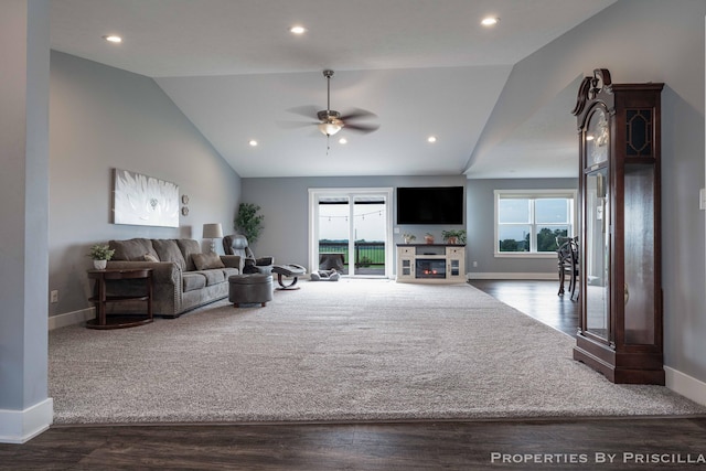 21491 8th Ave, Conklin, MI 49403 - living area with vaulted ceiling, a ceiling fan, wood finished floors, a glass covered fireplace, and recessed lighting