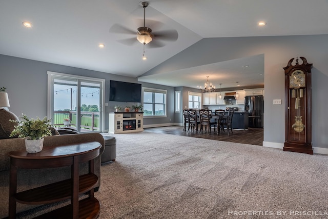 21491 8th Ave, Conklin, MI 49403 - living room with dark carpet, vaulted ceiling, ceiling fan, recessed lighting, and a chandelier