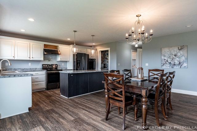 21491 8th Ave, Conklin, MI 49403 - dining room featuring dark wood-style floors, recessed lighting, and a chandelier
