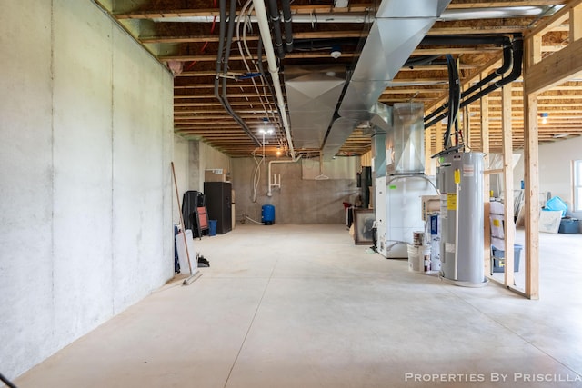 21491 8th Ave, Conklin, MI 49403 - unfinished below grade area featuring electric water heater, a water pressure tank, and heating unit