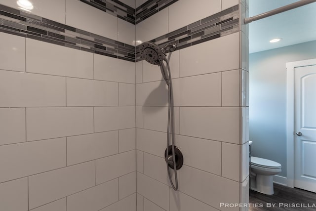 21491 8th Ave, Conklin, MI 49403 - bathroom with tiled shower, recessed lighting, and wood finished floors