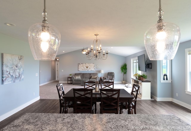 21491 8th Ave, Conklin, MI 49403 - dining space featuring wood finished floors, vaulted ceiling, and a chandelier