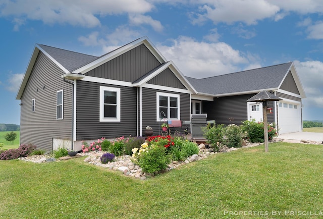 21491 8th Ave, Conklin, MI 49403 - view of front facade featuring a front lawn, an attached garage, board and batten siding, and driveway