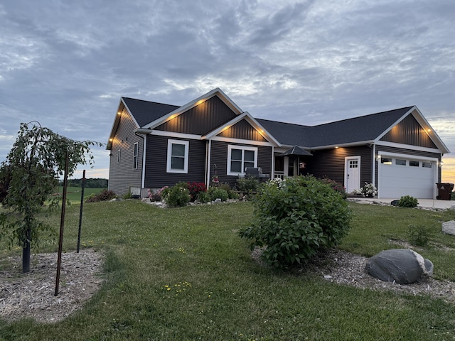 21491 8th Ave, Conklin, MI 49403 - view of front facade with a garage, a front yard, and board and batten siding