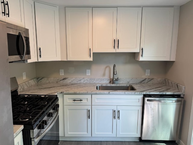 2159 E Eden Ct, Ann Arbor, MI 48108 - kitchen with appliances with stainless steel finishes, white cabinetry, and light stone countertops