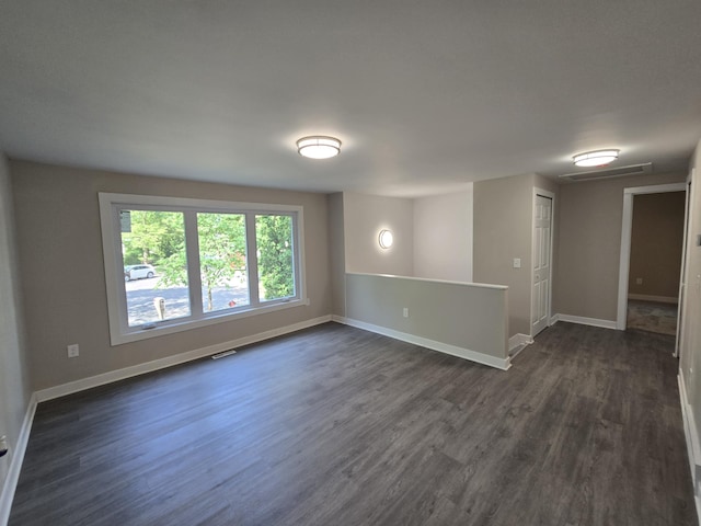 2159 E Eden Ct, Ann Arbor, MI 48108 - empty room featuring dark wood-style flooring and baseboards