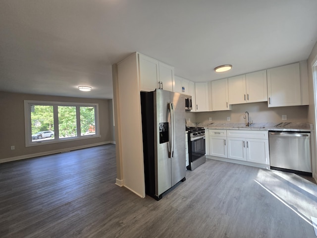 2159 E Eden Ct, Ann Arbor, MI 48108 - kitchen with stainless steel appliances, light wood-style floors, light stone counters, and white cabinets