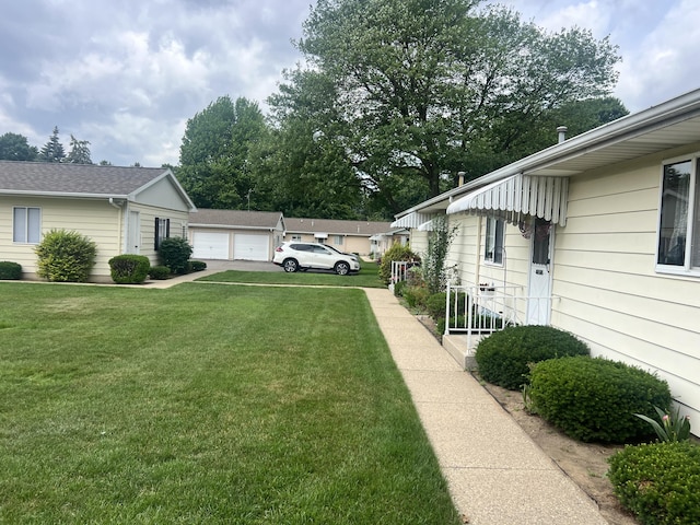 5804 Leisure S Dr SE, Grand Rapids, MI 49548 - view of grassy yard featuring a detached garage