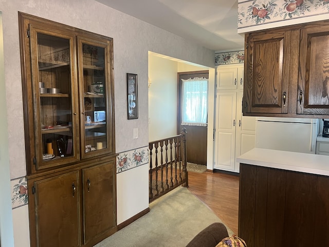 5804 Leisure S Dr SE, Grand Rapids, MI 49548 - kitchen featuring light countertops, wood finished floors, and dark brown cabinetry