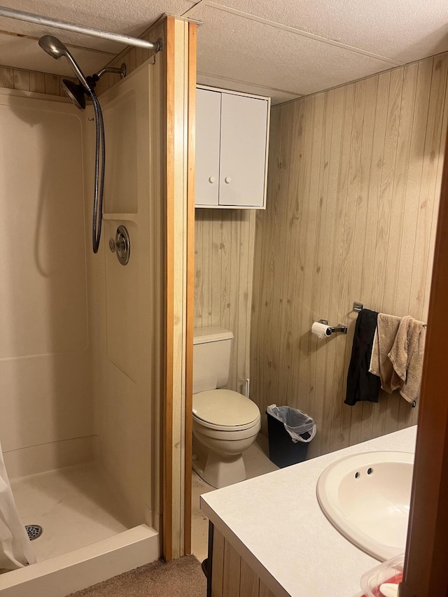 5804 Leisure S Dr SE, Grand Rapids, MI 49548 - full bathroom with a stall shower, wood walls, vanity, and a textured ceiling