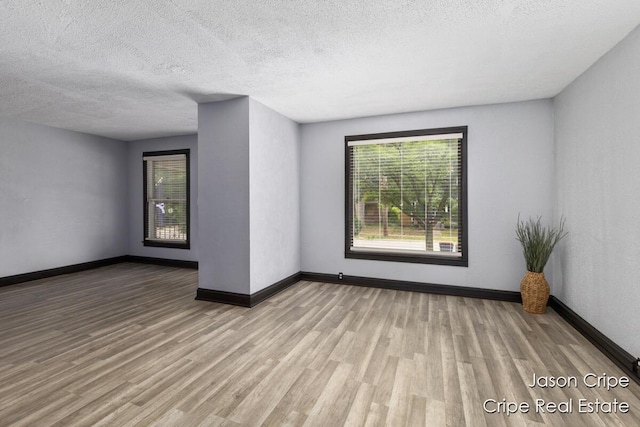 109 Fuller Ave SE, Grand Rapids, MI 49506 - empty room with wood finished floors and a textured ceiling