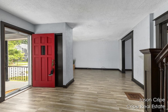 109 Fuller Ave SE, Grand Rapids, MI 49506 - entryway featuring wood finished floors and a textured ceiling
