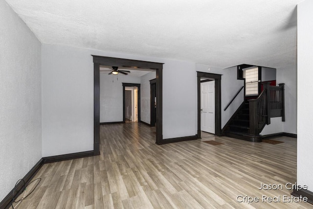 109 Fuller Ave SE, Grand Rapids, MI 49506 - unfurnished room featuring wood finished floors, stairway, ceiling fan, and a textured ceiling
