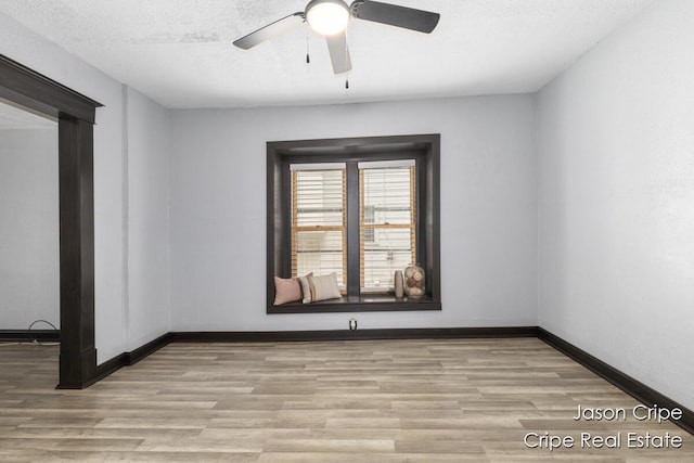 109 Fuller Ave SE, Grand Rapids, MI 49506 - empty room with wood finished floors, a ceiling fan, and a textured ceiling