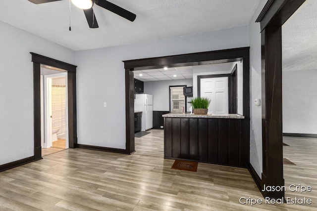109 Fuller Ave SE, Grand Rapids, MI 49506 - kitchen featuring freestanding refrigerator, wood finished floors, a ceiling fan, a peninsula, and a textured ceiling