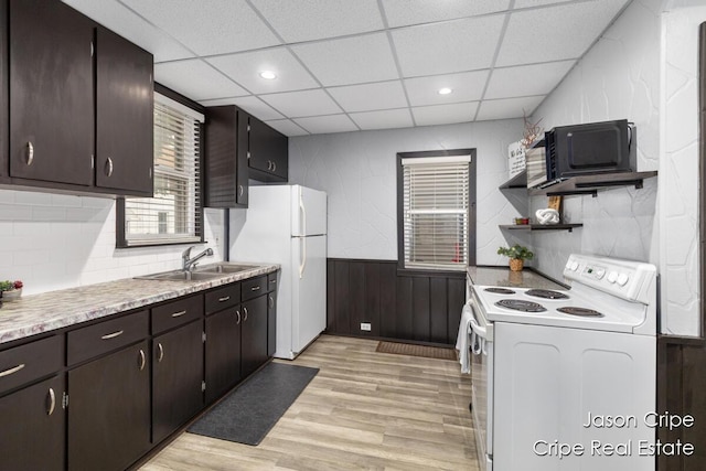 109 Fuller Ave SE, Grand Rapids, MI 49506 - kitchen featuring white appliances, light wood-style floors, a wainscoted wall, a drop ceiling, and light countertops