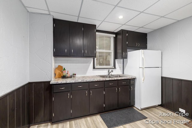 109 Fuller Ave SE, Grand Rapids, MI 49506 - kitchen with freestanding refrigerator, a paneled ceiling, light wood-style floors, light countertops, and a wainscoted wall