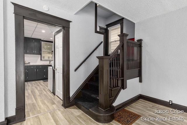 109 Fuller Ave SE, Grand Rapids, MI 49506 - staircase with wood finished floors and baseboards