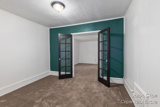 109 Fuller Ave SE, Grand Rapids, MI 49506 - carpeted spare room featuring french doors, a textured ceiling, and a decorative wall