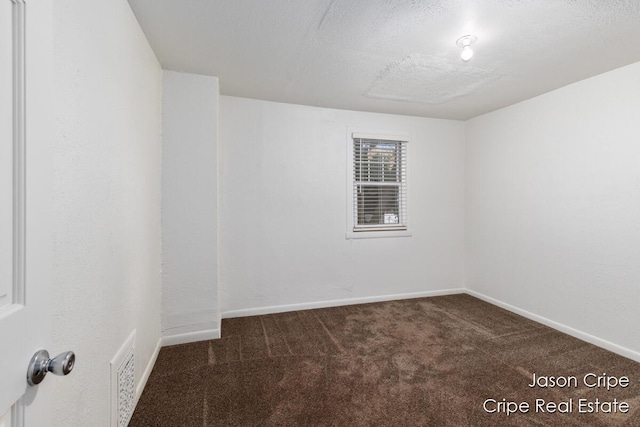 109 Fuller Ave SE, Grand Rapids, MI 49506 - unfurnished room with dark colored carpet and a textured ceiling