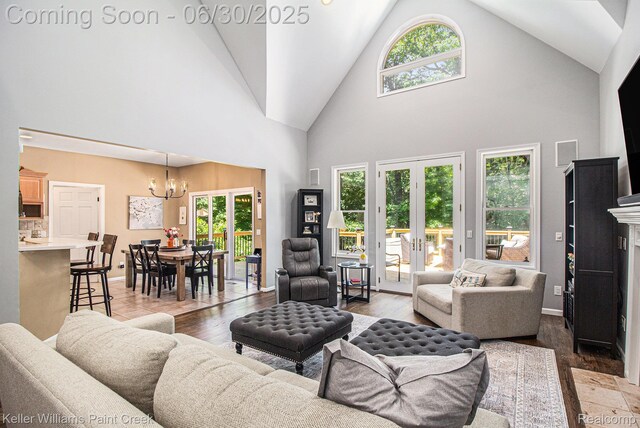 2868 Masters Ct, Pinckney, MI 48169 - living area with a chandelier, high vaulted ceiling, and wood finished floors