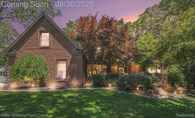 2868 Masters Ct, Pinckney, MI 48169 - view of front of house with a front lawn and brick siding
