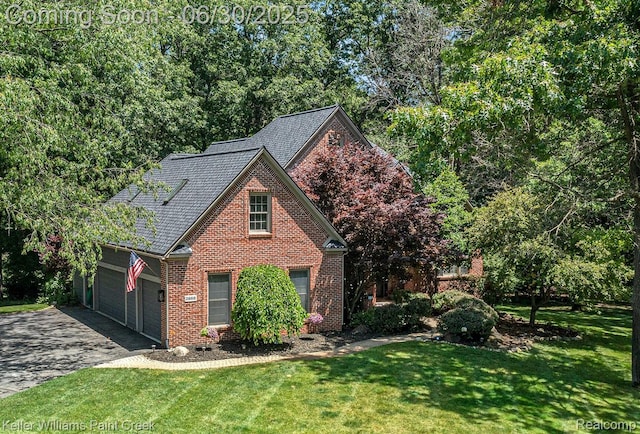 2868 Masters Ct, Pinckney, MI 48169 - traditional home featuring brick siding, asphalt driveway, a front lawn, and an attached garage